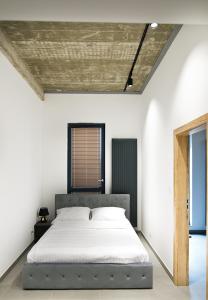 a bedroom with a bed in a white room at Apartamenty Dworcowa 60 in Gliwice