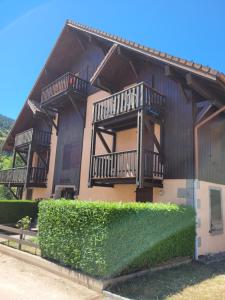 a house with balconies on the side of it at Appartement chaleureux au cœur des Hautes Vosges in Ventron