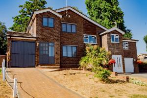 a brick house with a garage at Private Parking&Garden&Contractor&Families in Ipswich