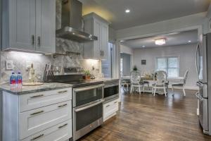 a kitchen with white cabinets and a dining room at Buckhead Atlanta Chateaumessage For Spring Dis! in Atlanta
