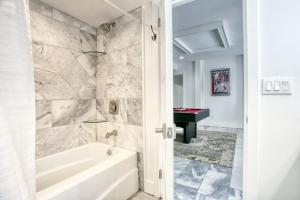 a bathroom with a tub and a sink at Buckhead Atlanta Chateaumessage For Spring Dis! in Atlanta