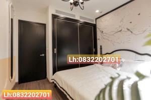 a bedroom with two large black doors and a bed at FLC Quy Nhơn Sea View Apartment - CHANH Căn Hộ Hướng Biển in Quy Nhon