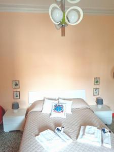 a bedroom with a bed with a chandelier at B&B BORGHI in Poppi
