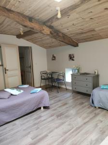 um quarto com 2 camas e uma mesa com cadeiras em Les Chenets em Chenay