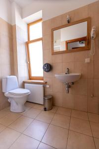 a bathroom with a toilet and a sink and a mirror at Priedes māja in Ainaži