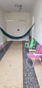 two chairs and a hammock in a room at Jardim Secreto in São Paulo