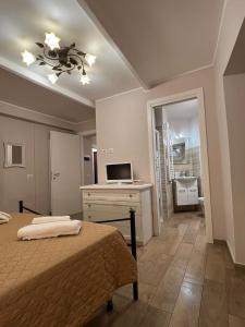 a bedroom with a bed and a desk and a television at Martinahouse in Vico nel Lazio