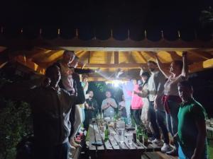 a group of people standing around a table with drinks at Casa Arabela in Vişeu de Sus