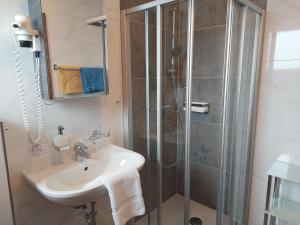 a bathroom with a shower and a sink at Pension Paßler in Seeboden +38 photos