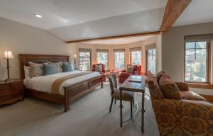 1 dormitorio con 1 cama, mesa y sillas en The Chateaux Deer Valley, en Park City