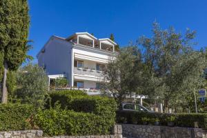a large white building with trees in front of it at Ivan & Anka apartments BOJKO in Selce