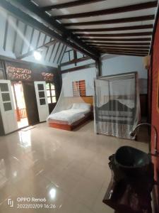 a large room with a bed and a tub at jala sutra cottages in Giri