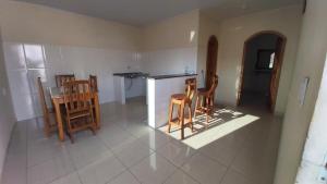 a kitchen with wooden chairs and a table at Apart Hotel M6D in Rio Branco +13 photos