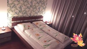 a bed with two pillows on it in a bedroom at Appartement Mijn Ouders Bed en Breakfast Emmeloord in Emmeloord
