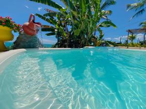 a swimming pool with a pink flamingo in the water at Montepascual Ecovillage in Lagoinha