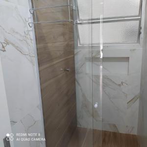 a shower with a glass door in a bathroom at Cheiro de Mar in Balneário Camboriú