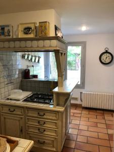 a kitchen with a stove top oven in a room at Détente à la compagne piscine chauffée billard et baby foot in Caugé