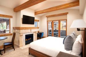 a living room with a tv and a bed at The Chateaux Deer Valley in Park City