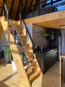 a staircase leading up to a kitchen in a house at Cold Land Chalé in Urubici