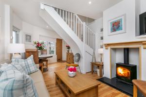 a living room with a fireplace and a staircase at The Nestle House in Winchester