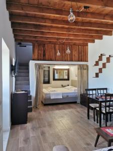 a bedroom with a bed and a table and chairs at Moscha's View House in Lipsoi
