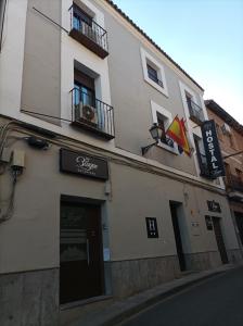 a building with a sign on the side of it at Hostal El Bosque Encantado Toledo in Toledo