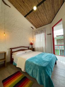 a bedroom with a bed and a large window at Salento_littlehouse in Salento