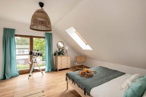 a bedroom with a camera and a table with a bowl of fruit at Grabowa 19 in Brzozówka +35 photos