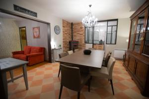 a living room with a dining room table and chairs at Chambre art deco Gatsby dans maison d'hote "Le Petit Clouet" - Rochecorbon in Rochecorbon