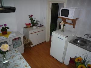 a small kitchen with a sink and a microwave at Villa Bambi in Sinaia