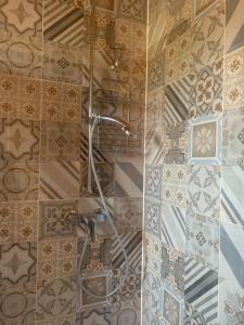 a shower in a bathroom with a tile wall at Vintage Apartment Wolf 