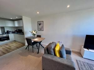 a living room with a couch and a table at Modern 1 Bedroom Apartment by BOLD Apartments in Liverpool
