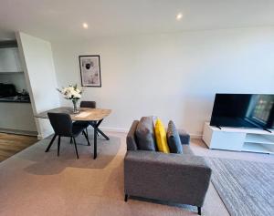 a living room with a couch and a table at Modern 1 Bedroom Apartment by BOLD Apartments in Liverpool