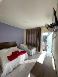 Posteľ alebo postele v izbe v ubytovaní Hotel e Pousada Império Barão