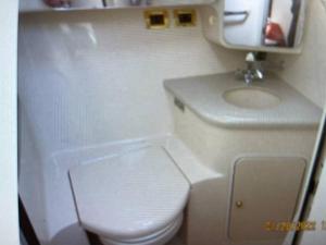 a small bathroom with a toilet and a sink at Delightful 2 Bdrm Sport Yacht with Pool in Pompano Beach