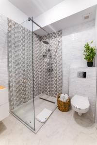 a bathroom with a glass shower and a toilet at SOLMAR Studio Sea View in Năvodari +21 photos