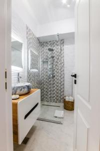 a white bathroom with a shower and a sink at SOLMAR Studio Sea View in Năvodari