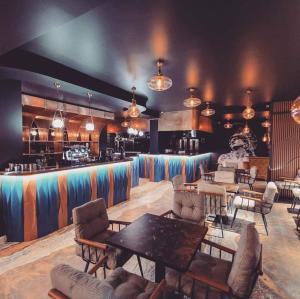 a room with tables and chairs and a bar at SOLMAR Studio Sea View in Năvodari