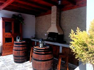 a kitchen with two wine barrels and a stove at LA CAÑADA in Tiscamanita