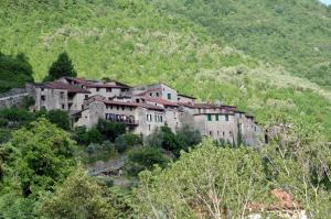 a group of buildings on the side of a mountain at Agriturismo Mulino del Castello Nasino in Nasino