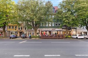 a street with cars parked in front of a building at Like King Friedrich - Kicker - Parking - Kitchen in Friedberg