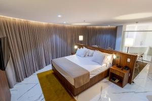 En eller flere senge i et værelse på Hotel Cassino Tower São José do Rio Preto by Nacional Inn