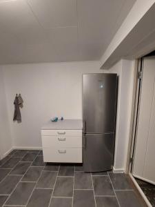 a kitchen with a stainless steel refrigerator in a room at Stuelejlighed med have og overdækket terrasse in Odense +11 photos