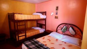 a small room with two bunk beds in it at La Casa del Manzano in Puno