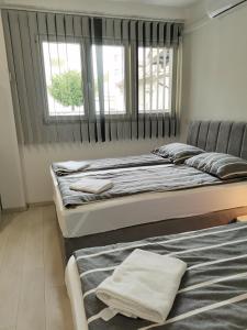A bed or beds in a room at Apartments Petrova170