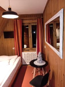 una camera da letto con un letto e un tavolo con un cappello sopra di Willa Kasprusie a Zakopane