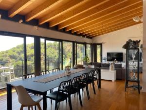 a dining room with a large table and chairs at Ece Golden Villa Amazing 4 bedroom vila with pool in Alella