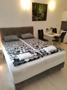 a large bed in a room with a table and chairs at Apartments Petrova170 in Zagreb