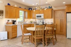 a kitchen with wooden cabinets and a table and chairs at Woodland Legacy-Escape to unwind in Mount Vernon