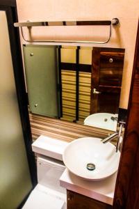 a bathroom with a sink and a mirror at Luxury Home Ixtapa Balcony Pool BBQ AA WIFI 250mbs! in Ixtapa